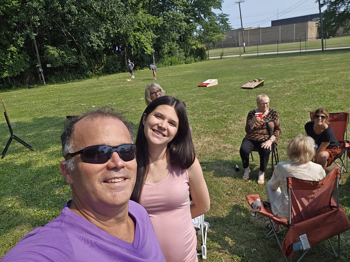 Outdoor lawn with cornhole and picnic area