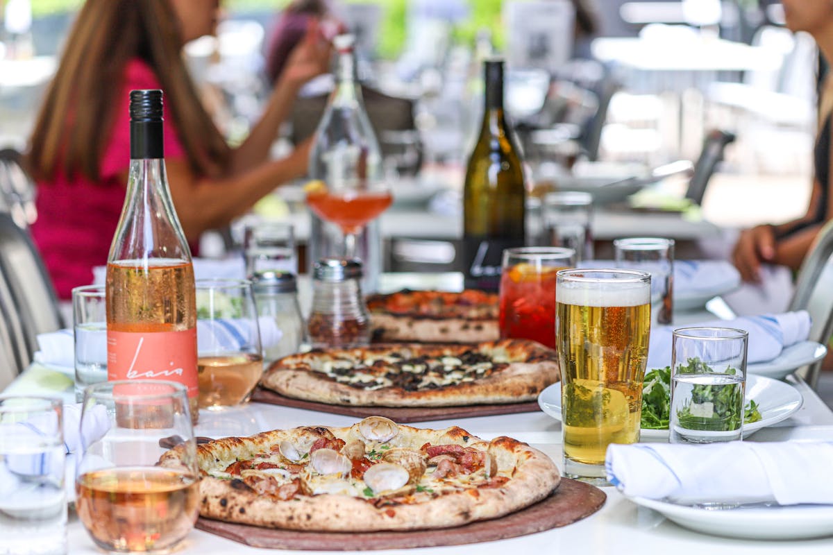 Bigalora official site wine-and-table image from the Royal Oak location