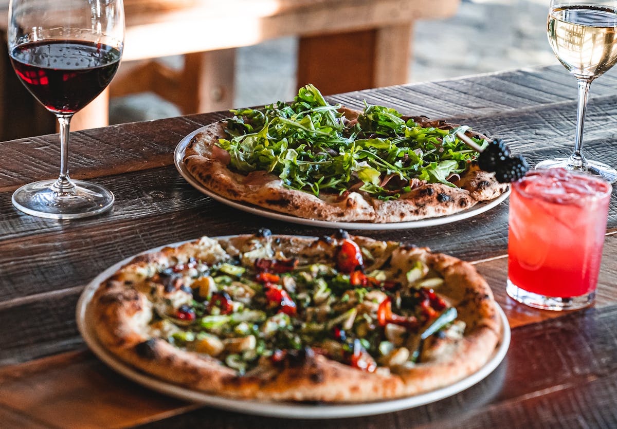 A close up of a plate of food and glasses of wine from the official site
