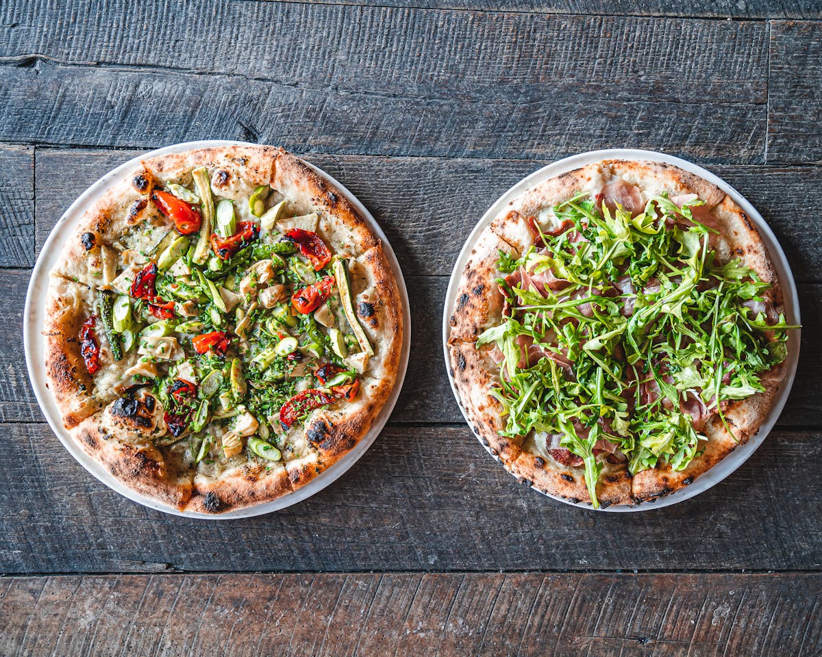 A pizza sitting on top of a wooden table from the official site